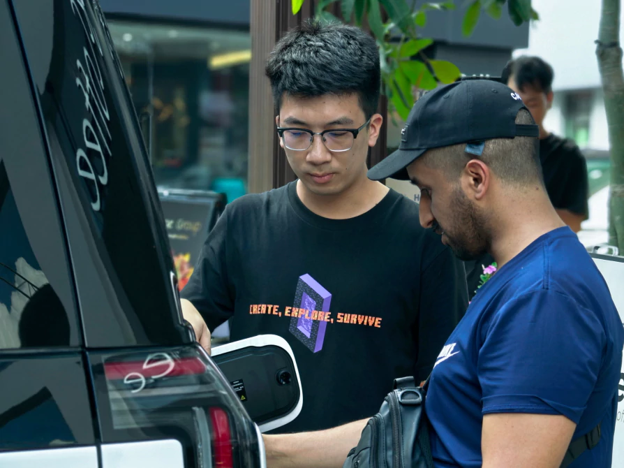 Business manager explaining cars to customers